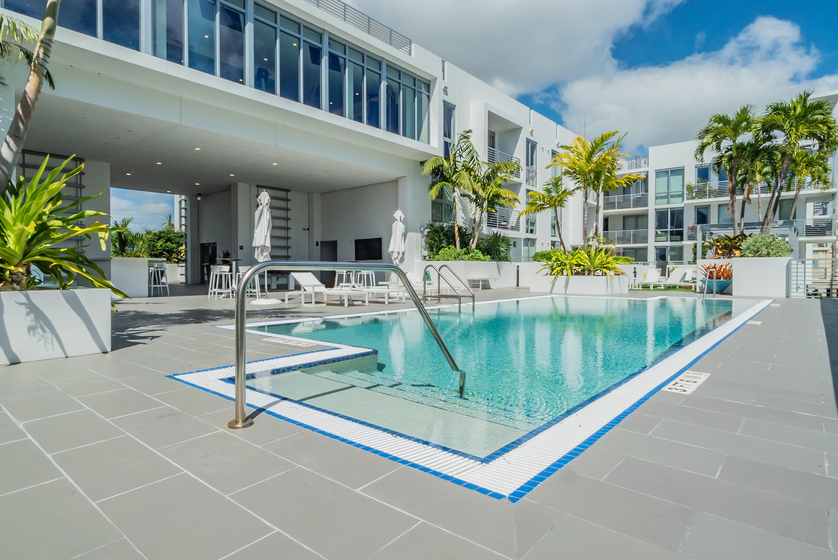 a view of a swimming pool with outdoor seating