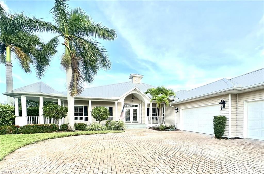 Ranch-style house featuring a garage and covered porch