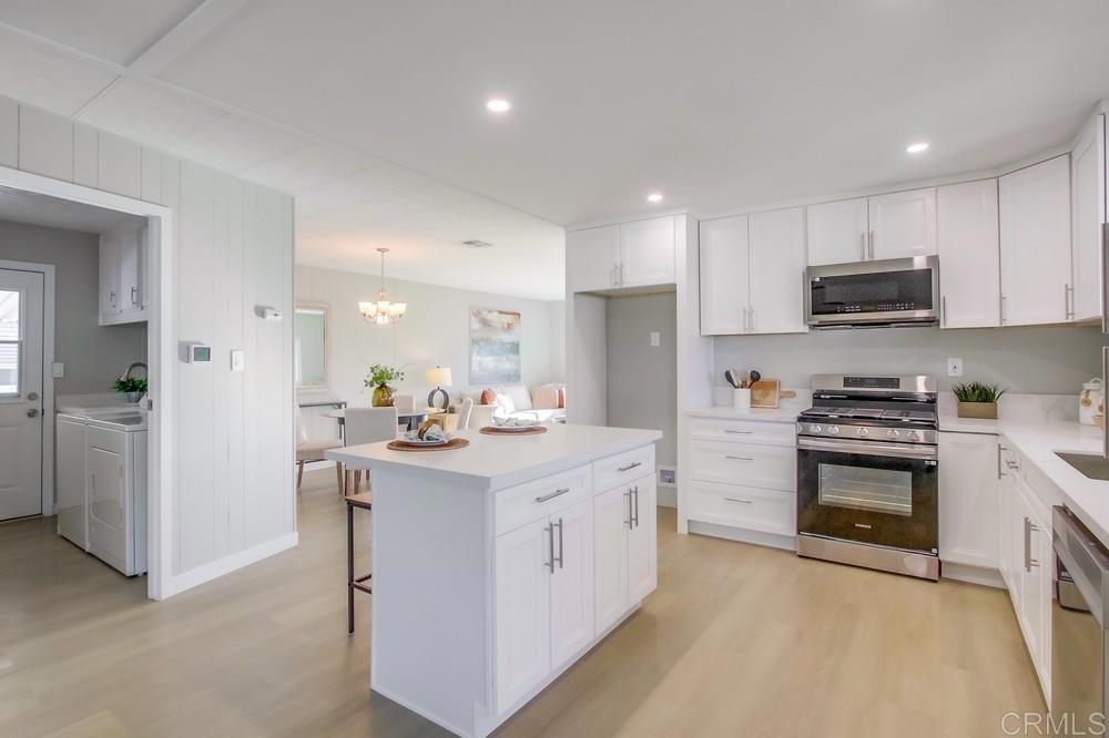 a kitchen with a sink stove and refrigerator