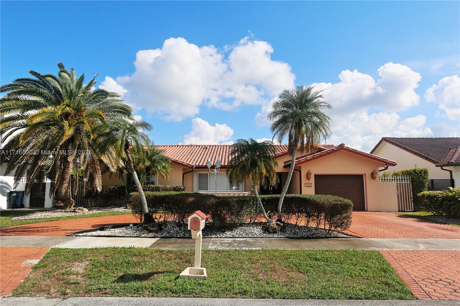 a front view of a house with garden and patio