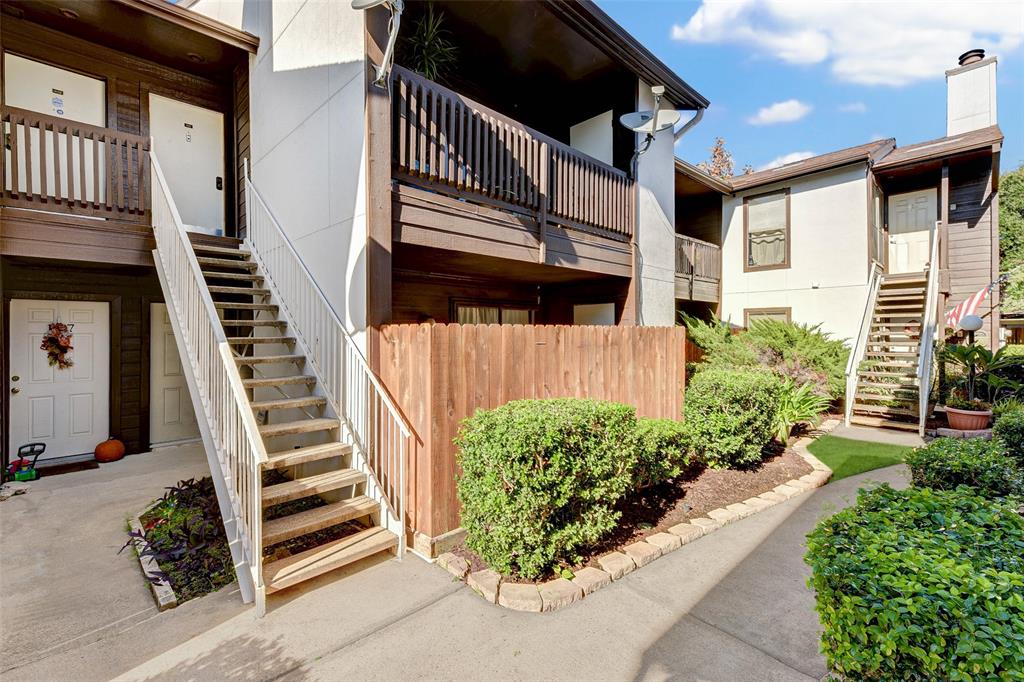 a view of a house with entryway and wooden stairs