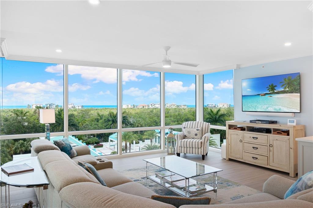 a living room with furniture and a floor to ceiling window