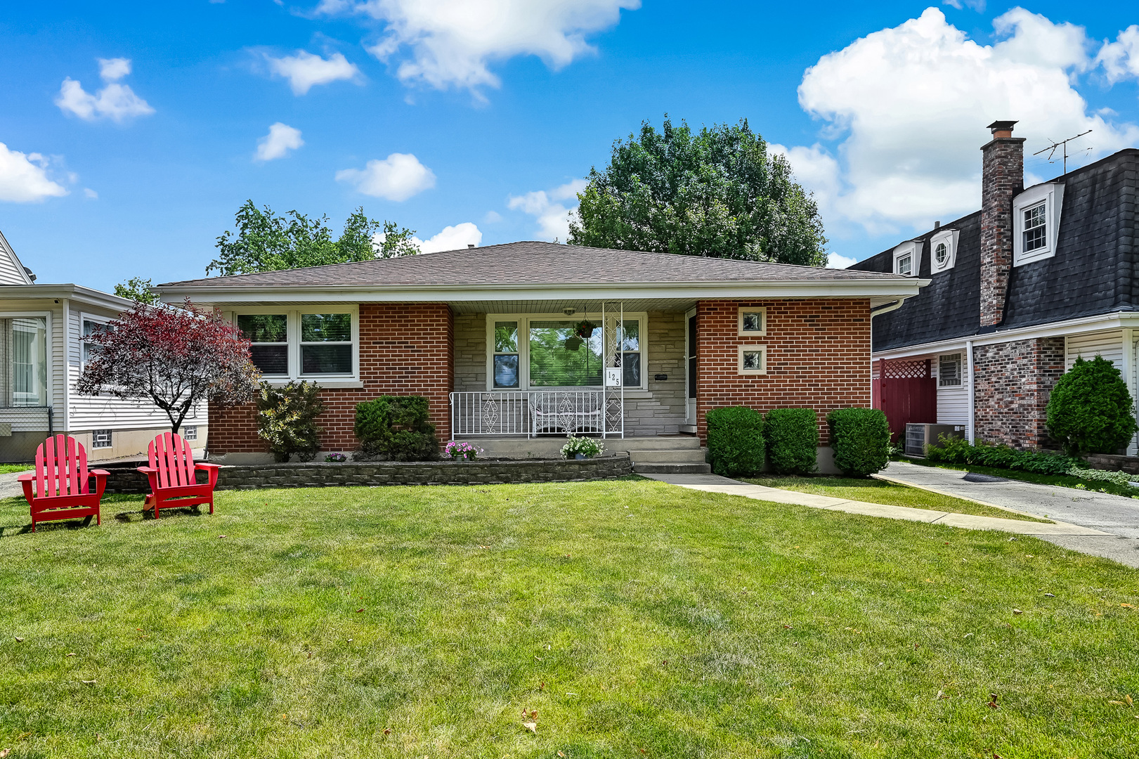 a front view of house with yard and green space