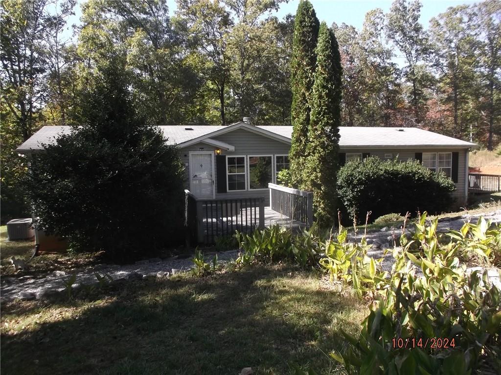 a view of a house with a yard and sitting area