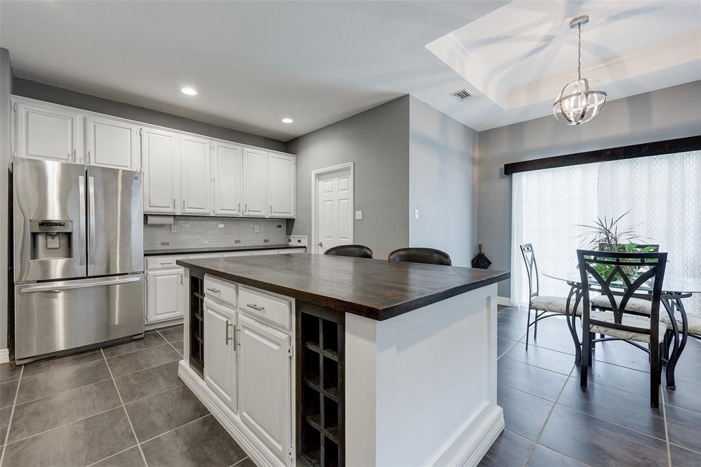 a kitchen with stainless steel appliances granite countertop a sink a stove and refrigerator