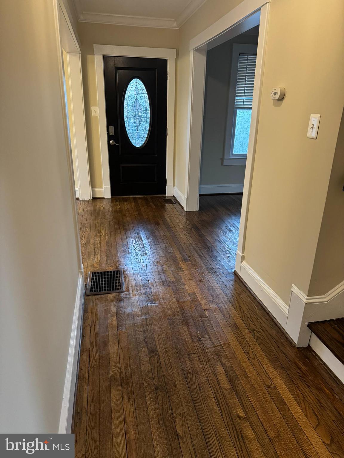 a view of a room with wooden floor and white wall