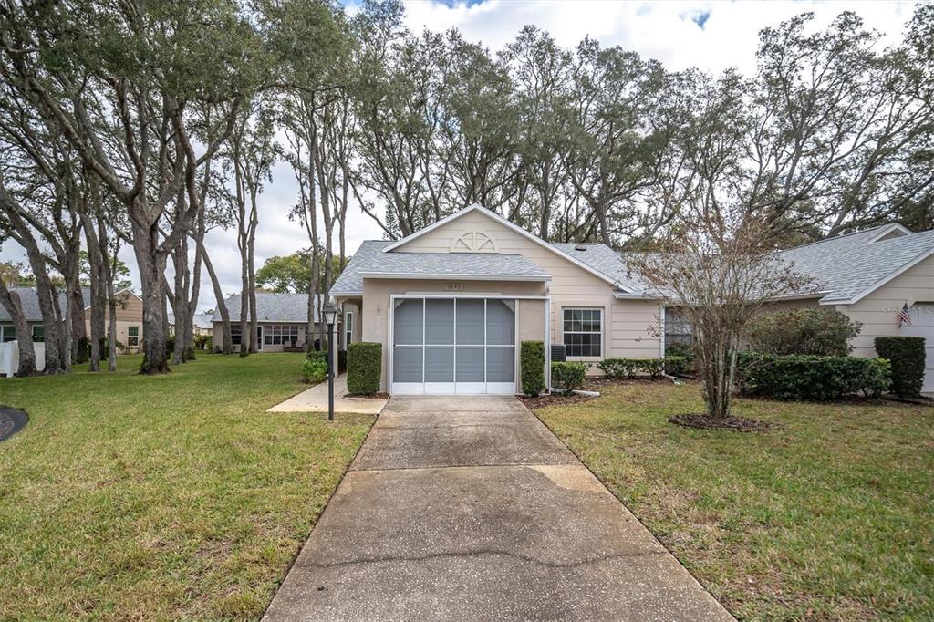 a front view of a house with a yard and trees