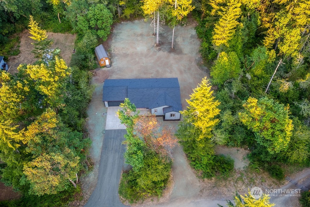 an aerial view of a house with a yard