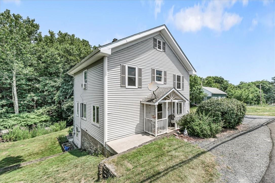 Back of property with a porch and a yard