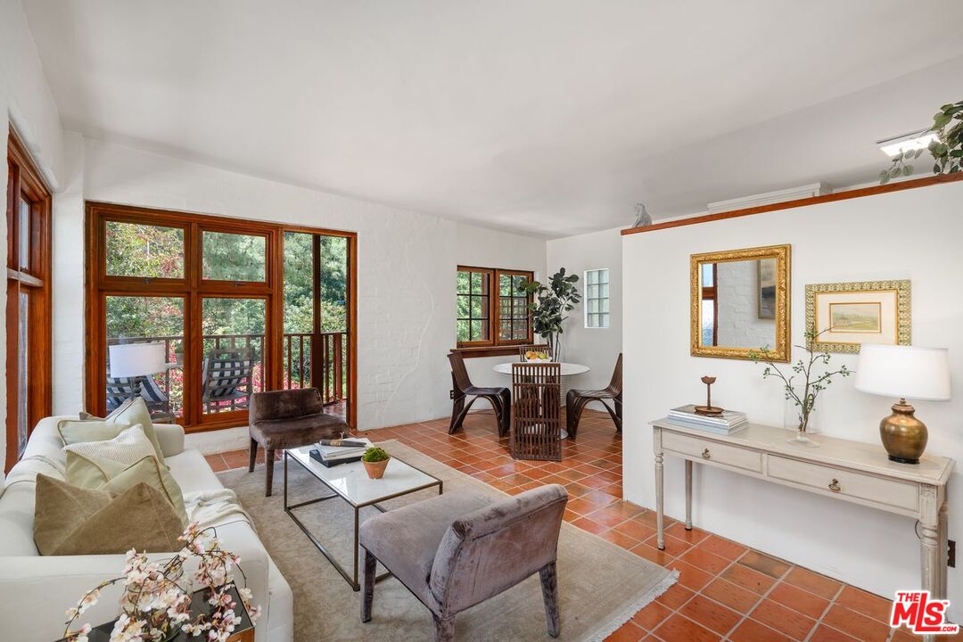 a living room with furniture and large window