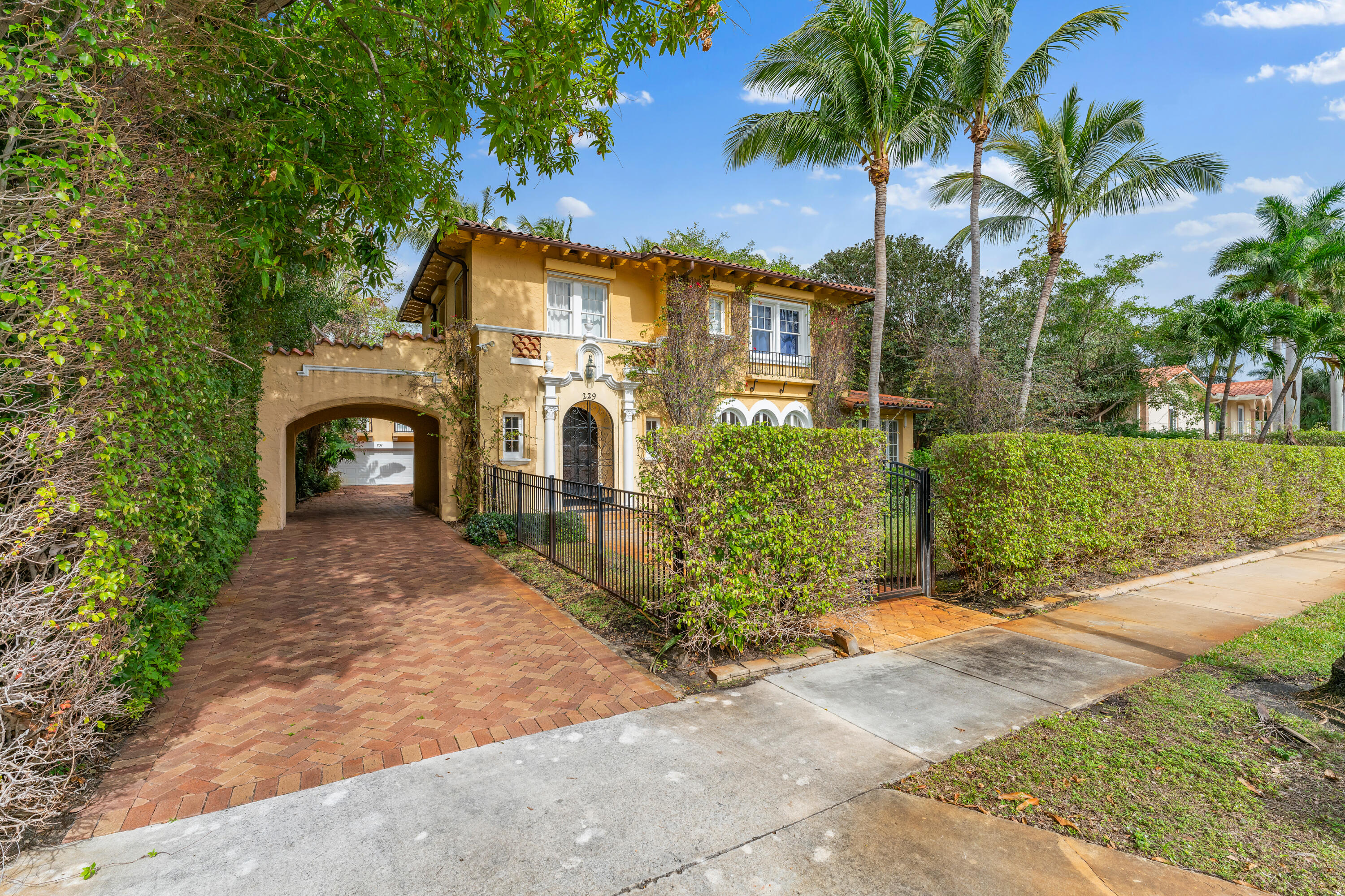 a view of a front of house with a yard and potted plants