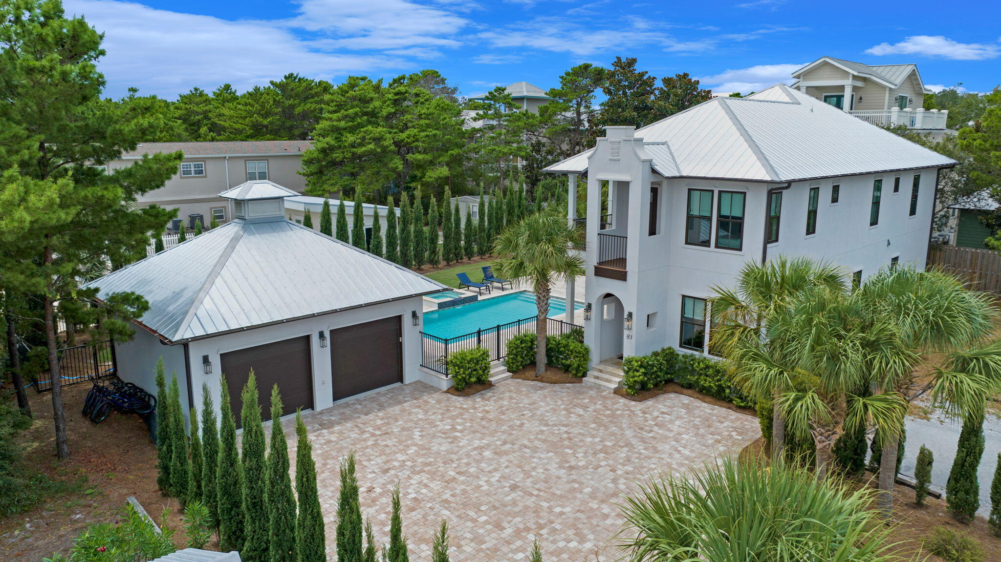 a aerial view of a house with a yard and potted plants