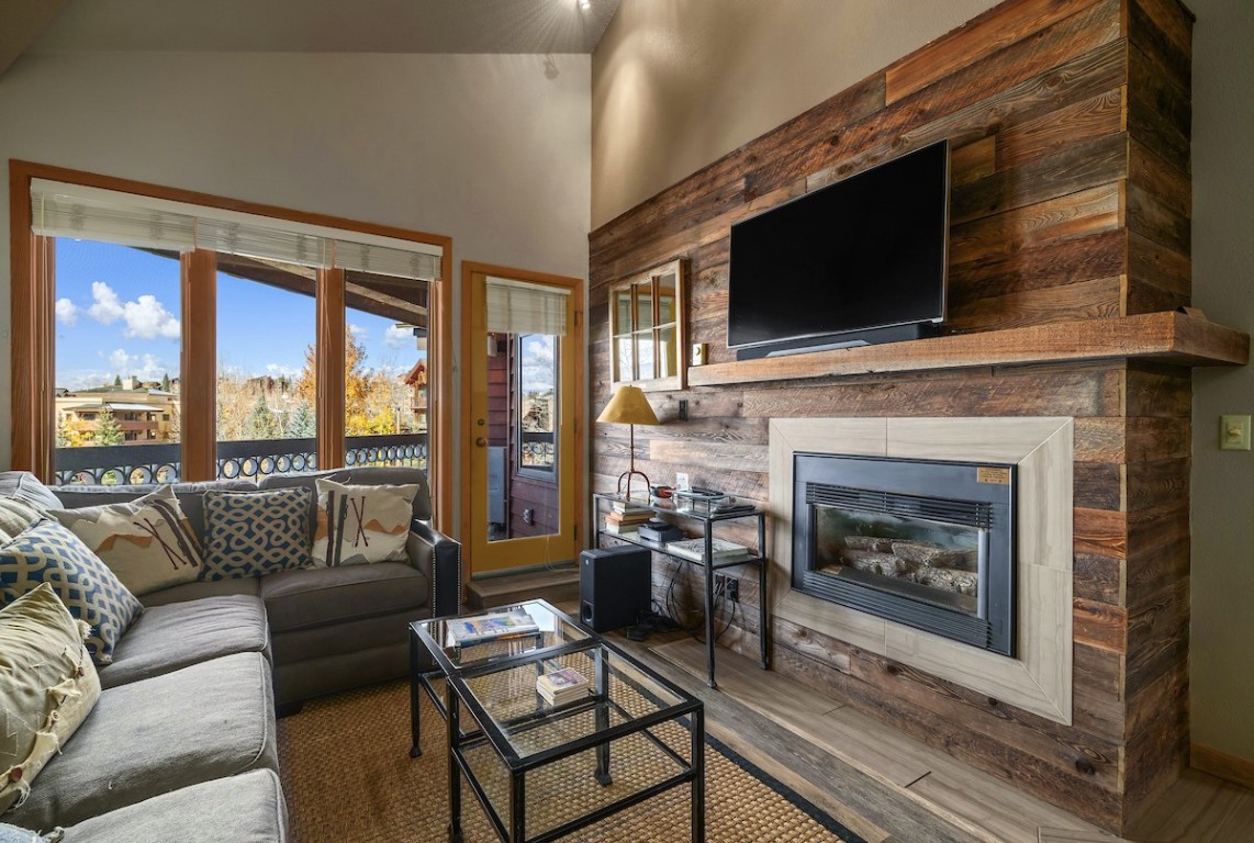 a living room with a fireplace and a flat screen tv