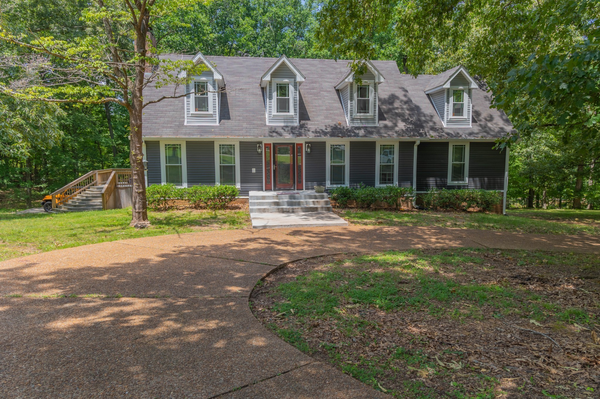 a front view of house with yard and green space