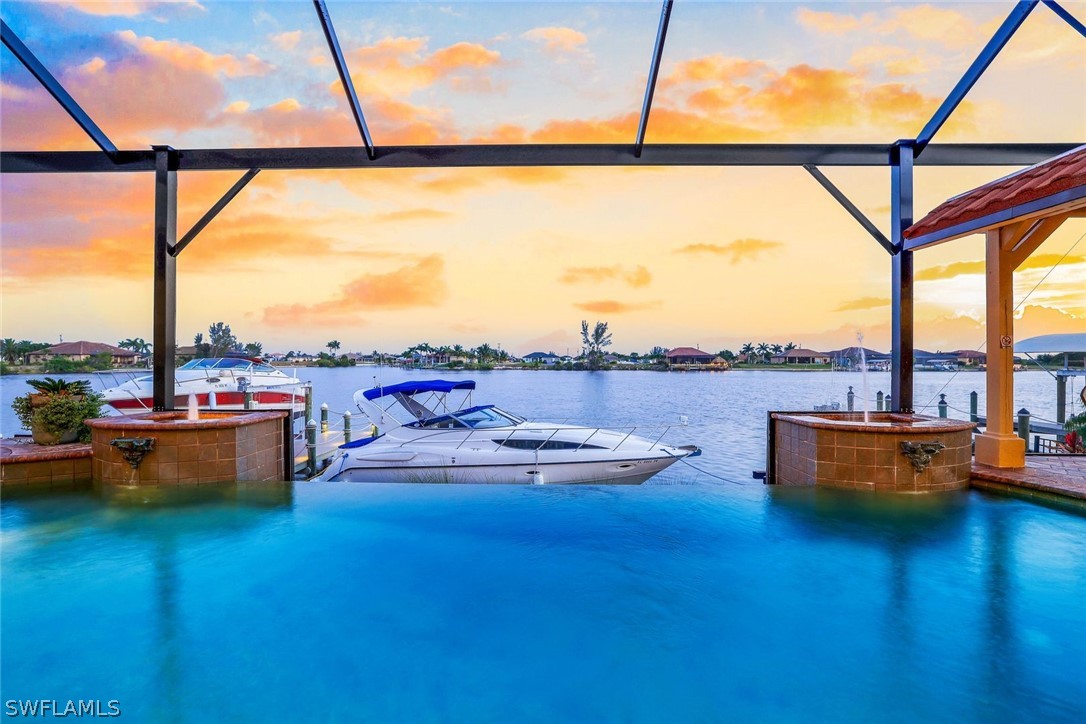 a view of swimming pool with a table and chairs