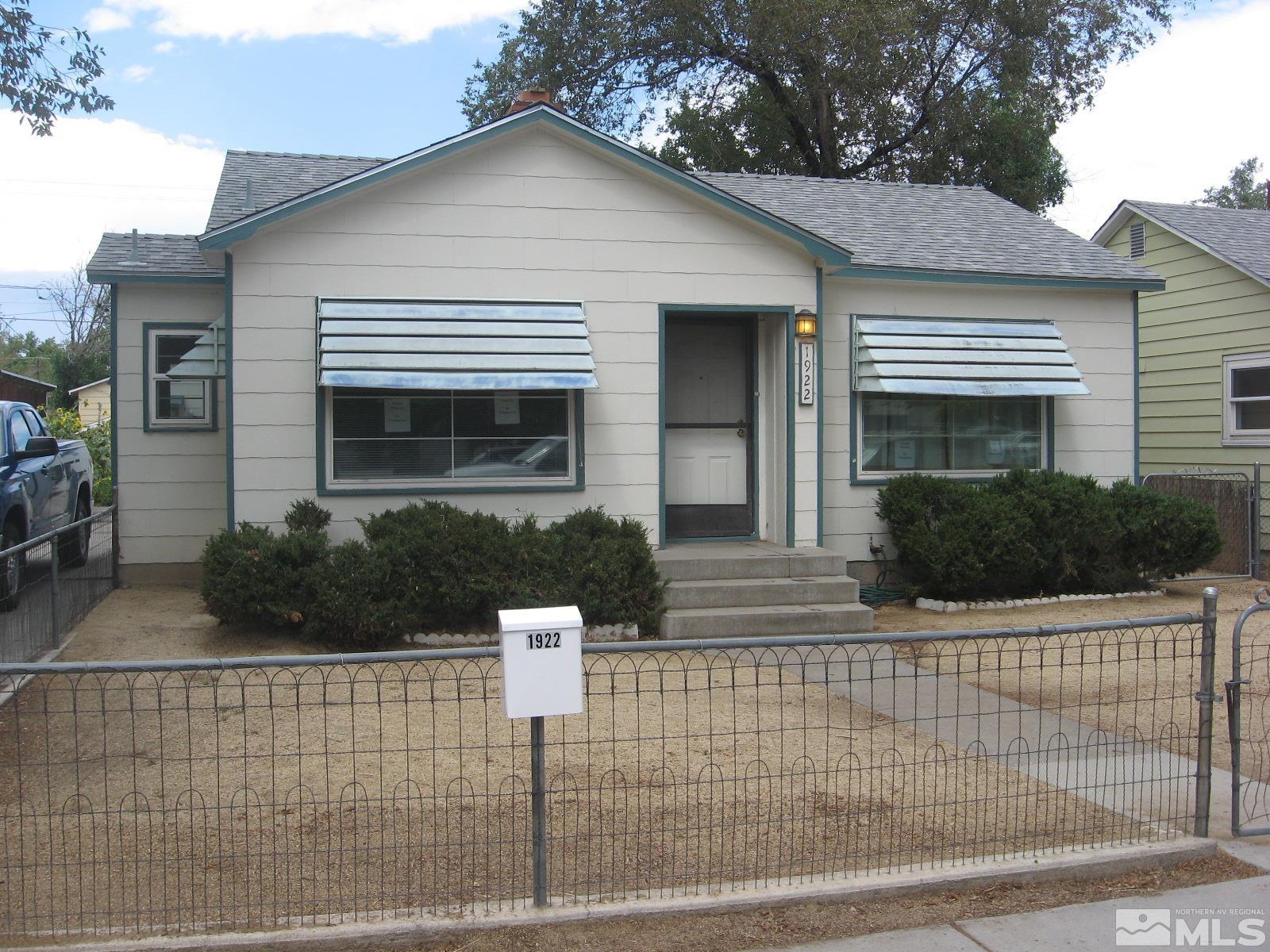 a front view of a house with plants