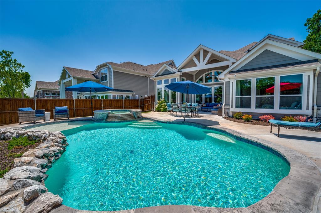 a front view of a house with swimming pool and furniture