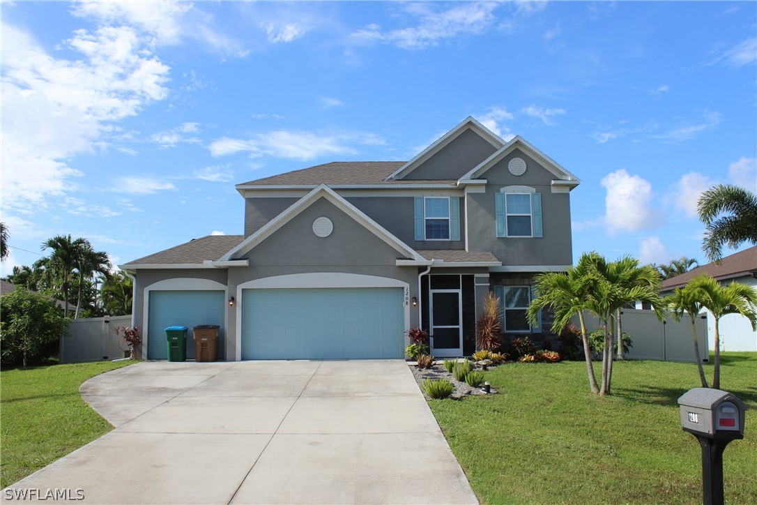 a front view of a house with a garden and yard