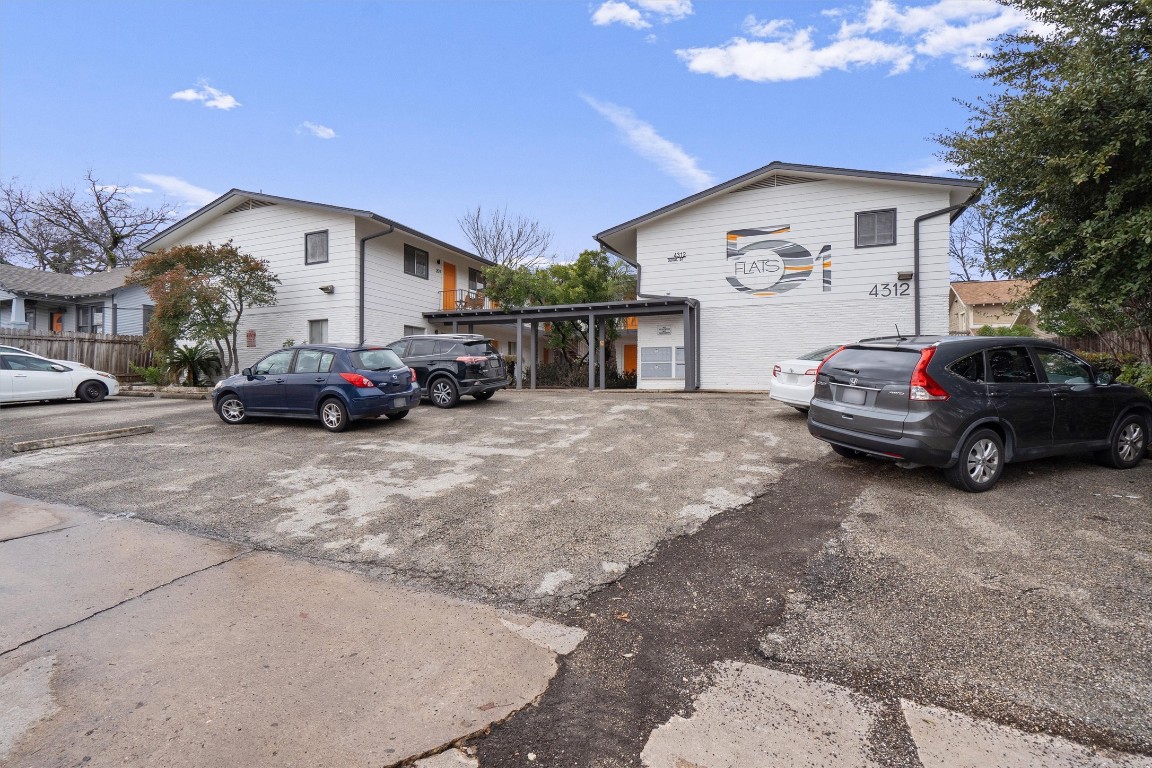 a view of a car park in front of house