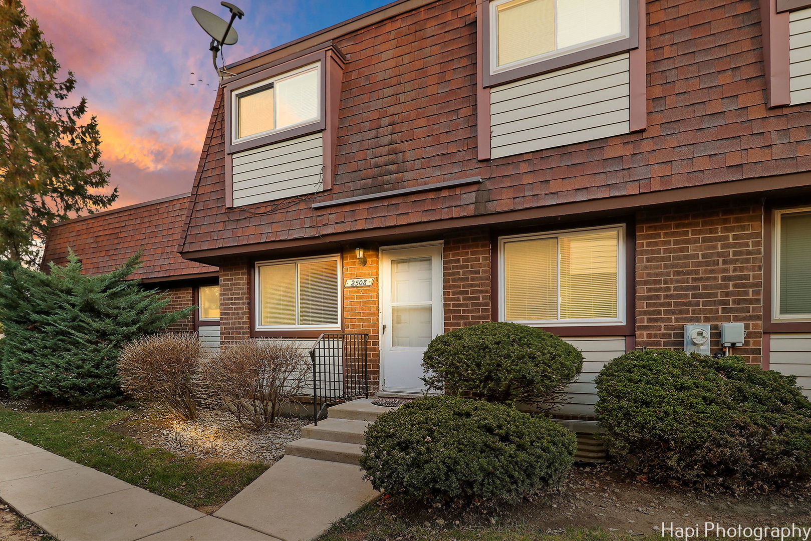 a view of a house with brick walls and windows