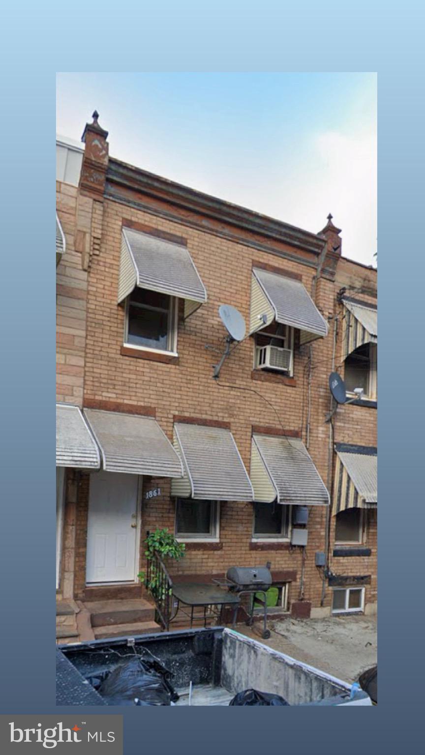 a view of a house with a balcony and a floor to ceiling window