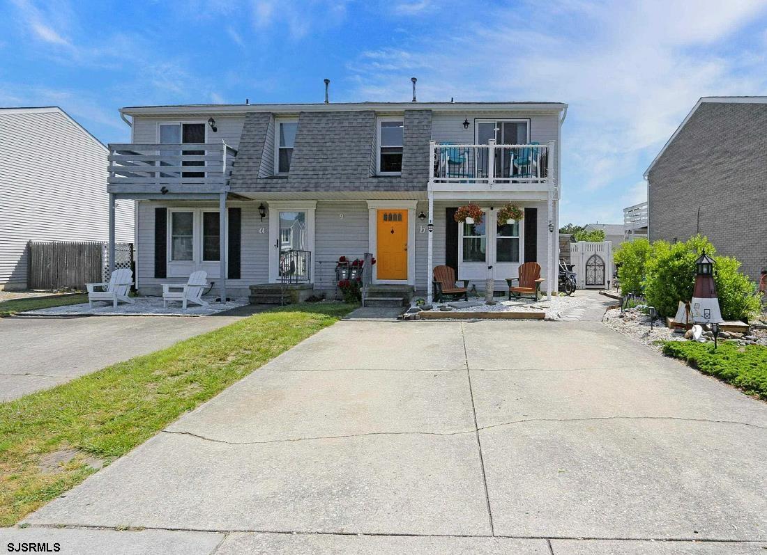 a front view of multiple houses with yard