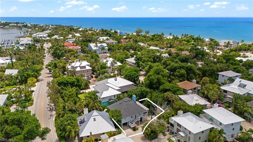 Raised beach house featuring a deck and central AC