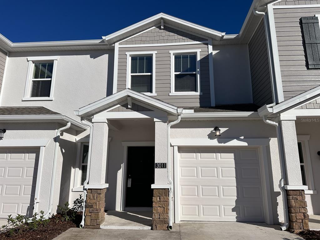 a front view of a house with garage