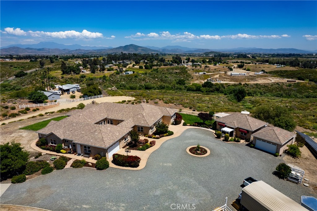 an aerial view of a house with yard