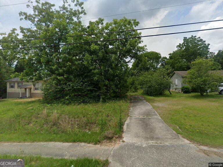 a view of a street with a tree in the background