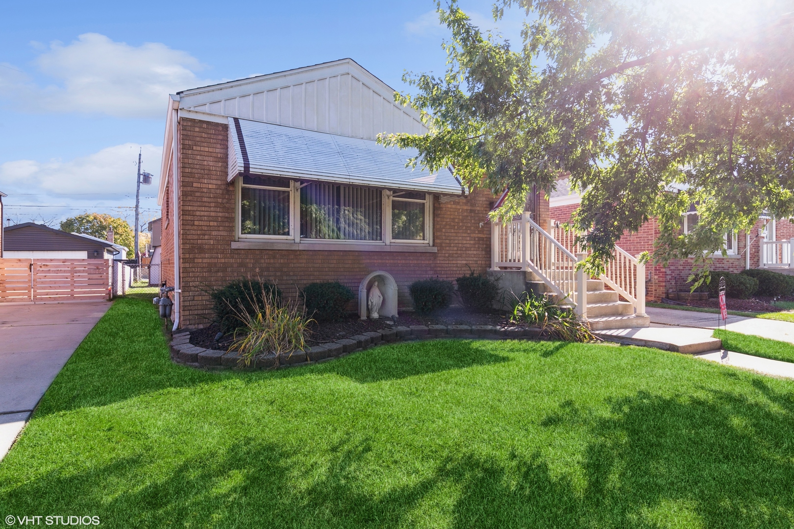 a front view of a house with garden and a yard