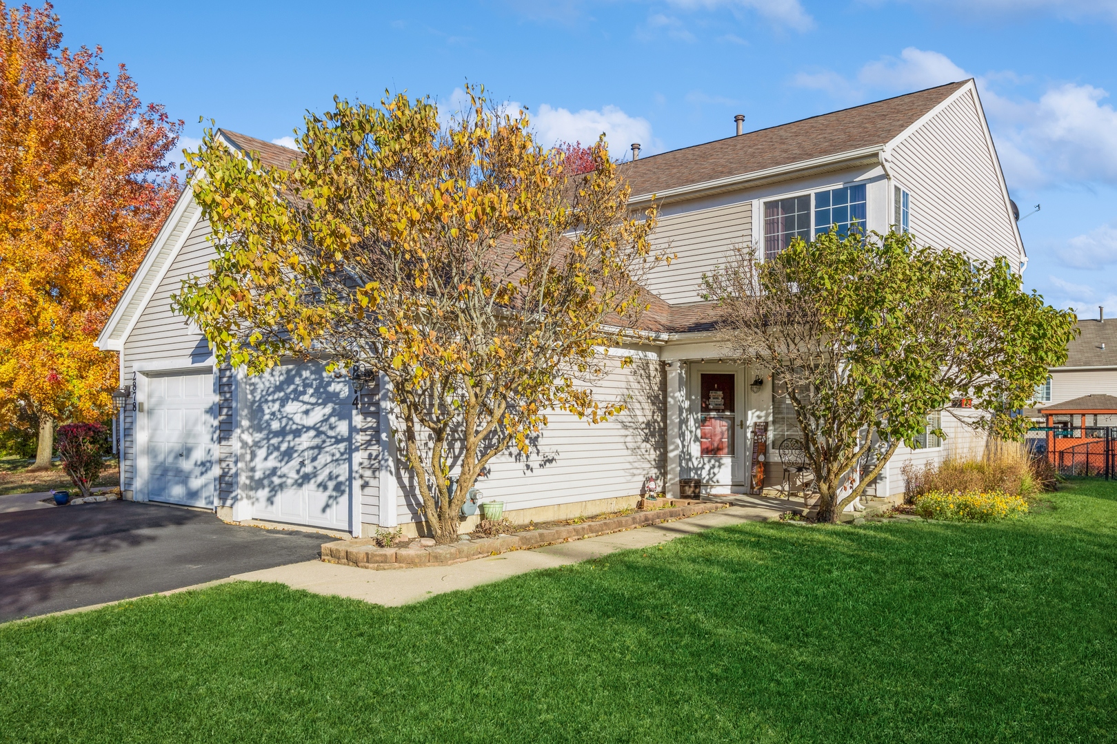 a view of a house with a tree and a yard