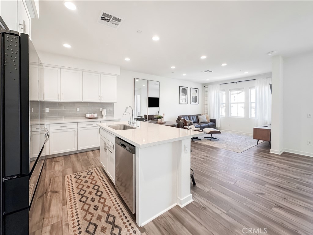 a kitchen with a sink window and cabinets