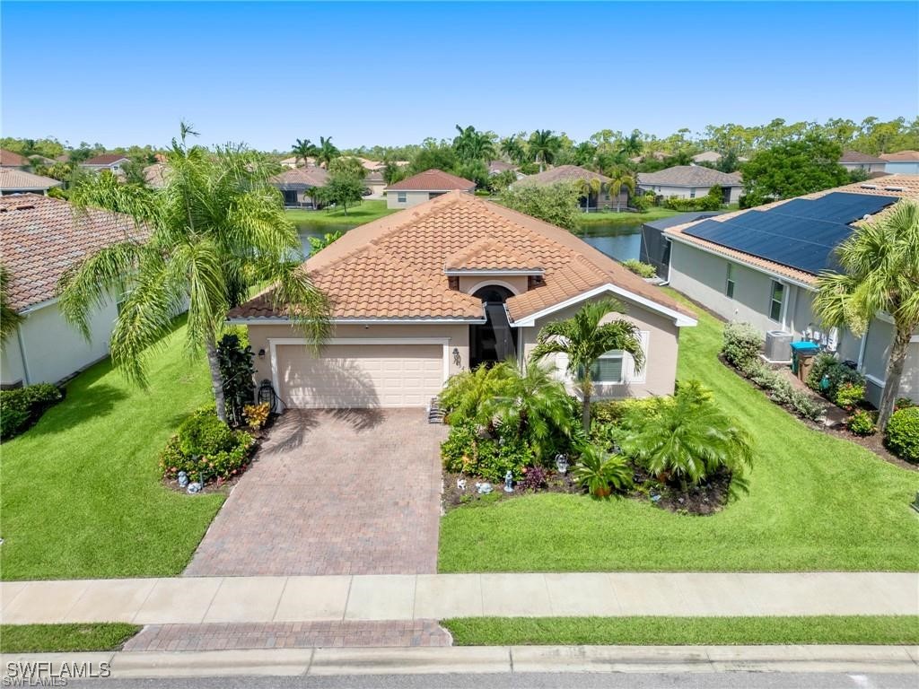 a aerial view of a house with a yard and potted plants