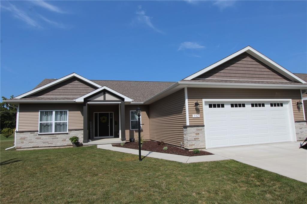 a view of a house with a yard and garage