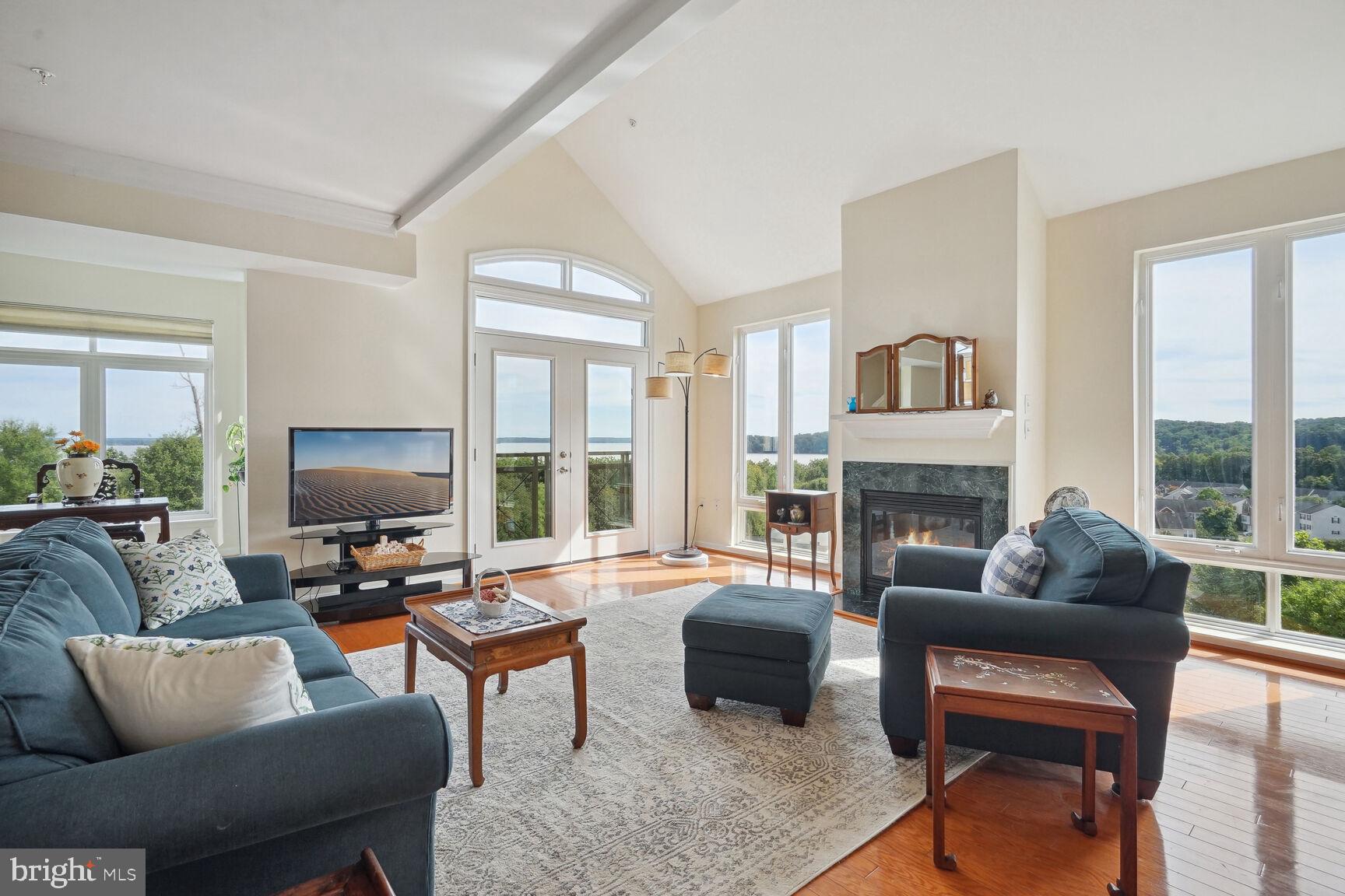 a living room with furniture fireplace and a large window