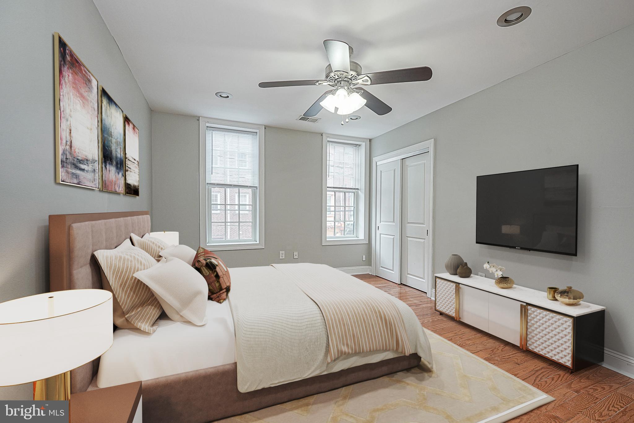 a bedroom with a bed and a flat screen tv