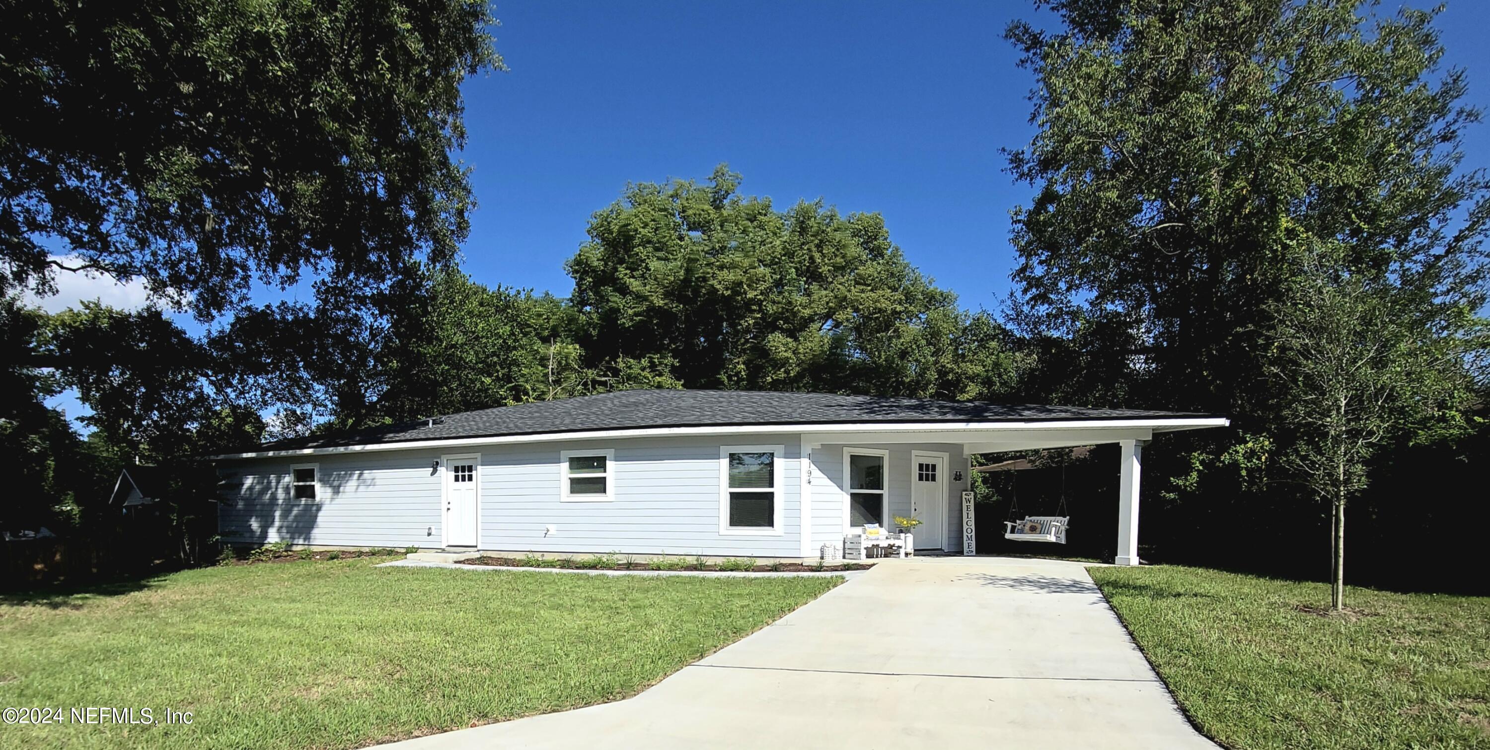 a front view of house with yard and green space