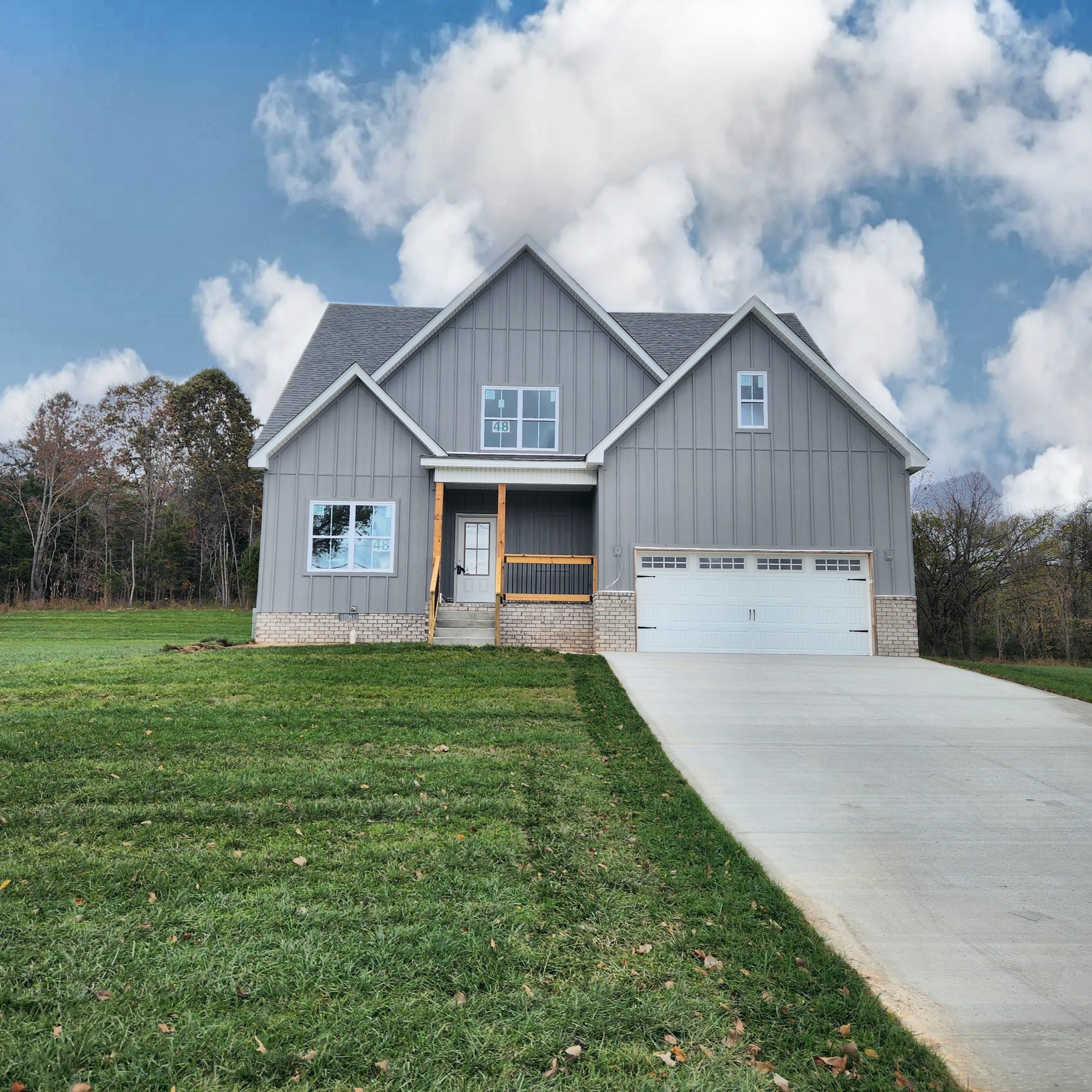 a front view of house with yard and green space