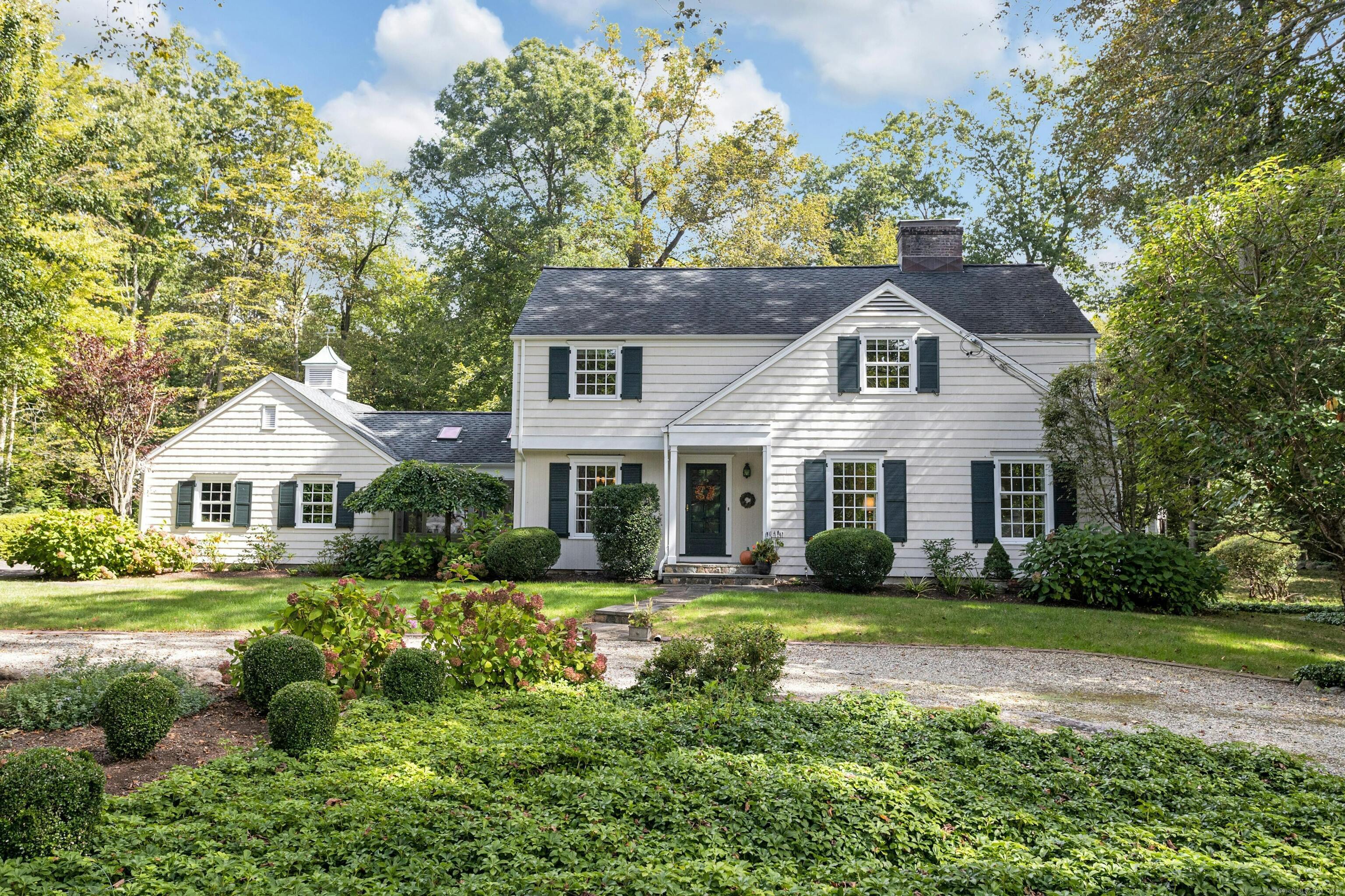 a front view of a house with a garden