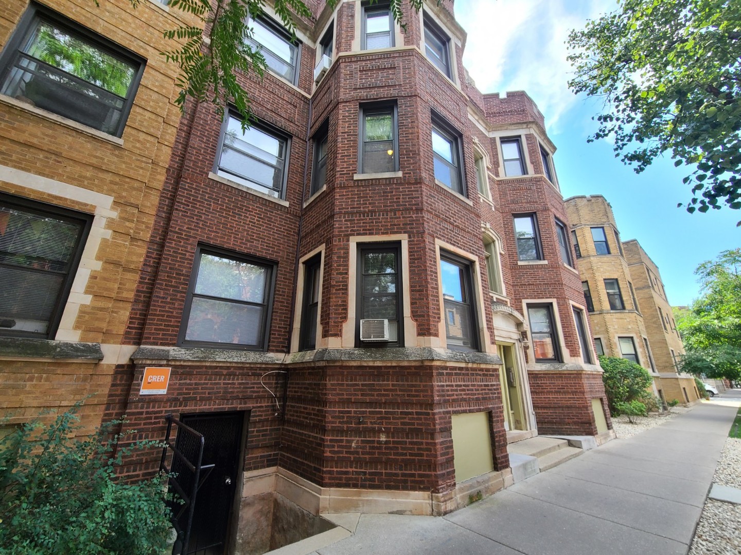 a tall building with a window and balcony