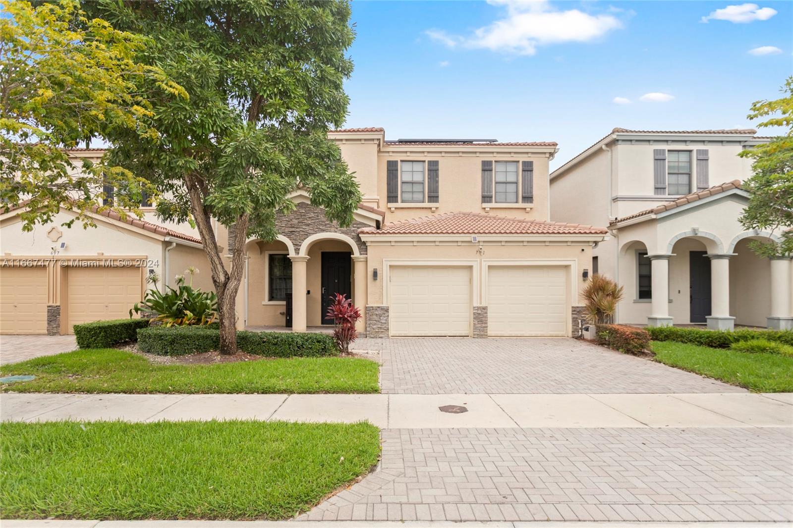 a front view of a house with a yard and garage