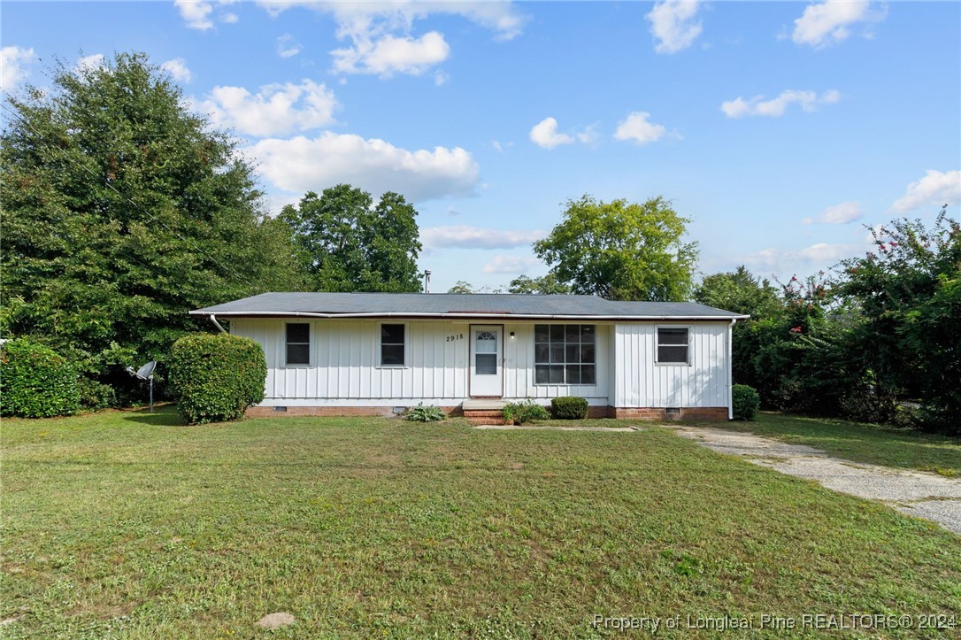 a front view of house with yard and green space