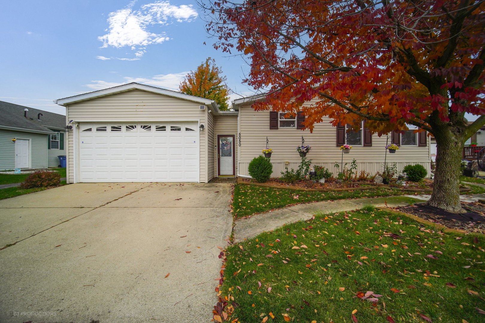 a view of a house with a yard and garage