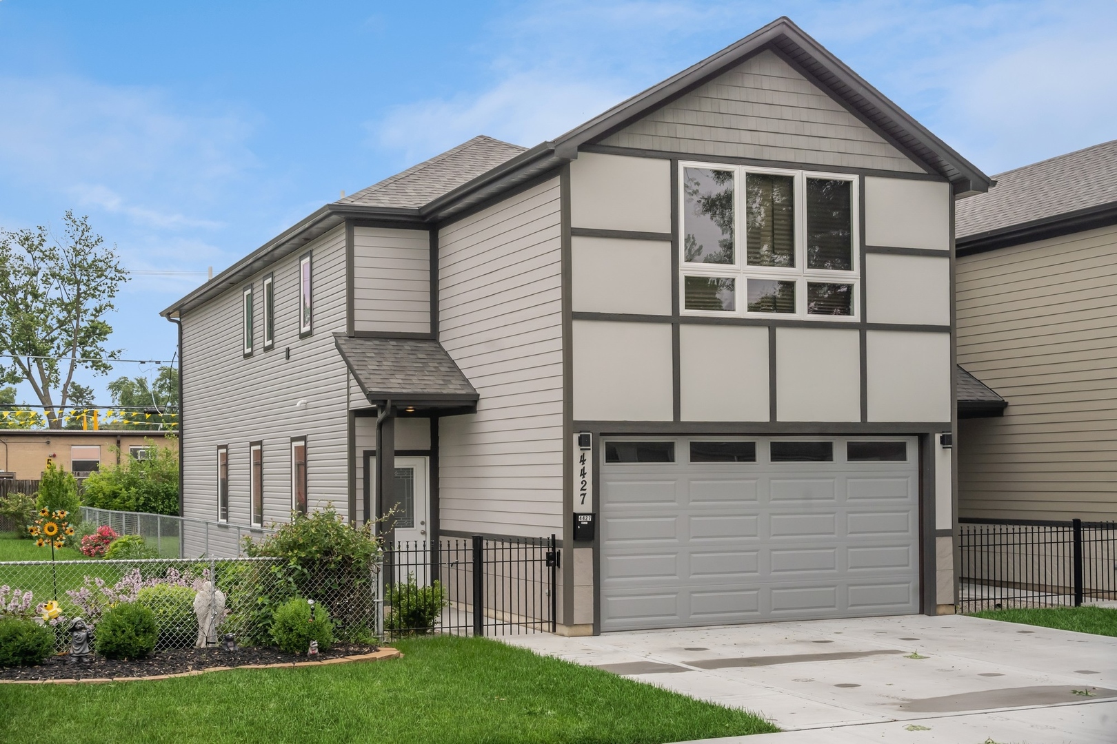 a front view of a house with a yard and garage