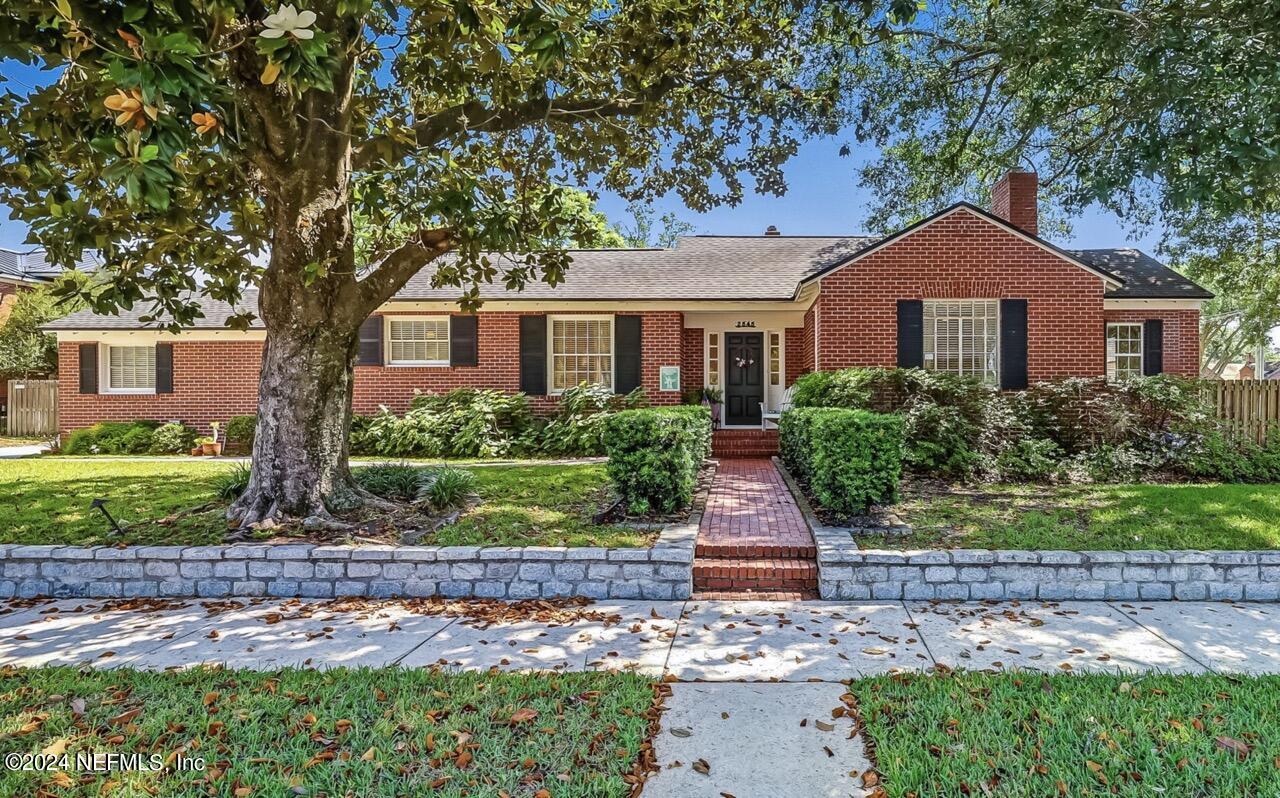 a front view of house with yard and green space