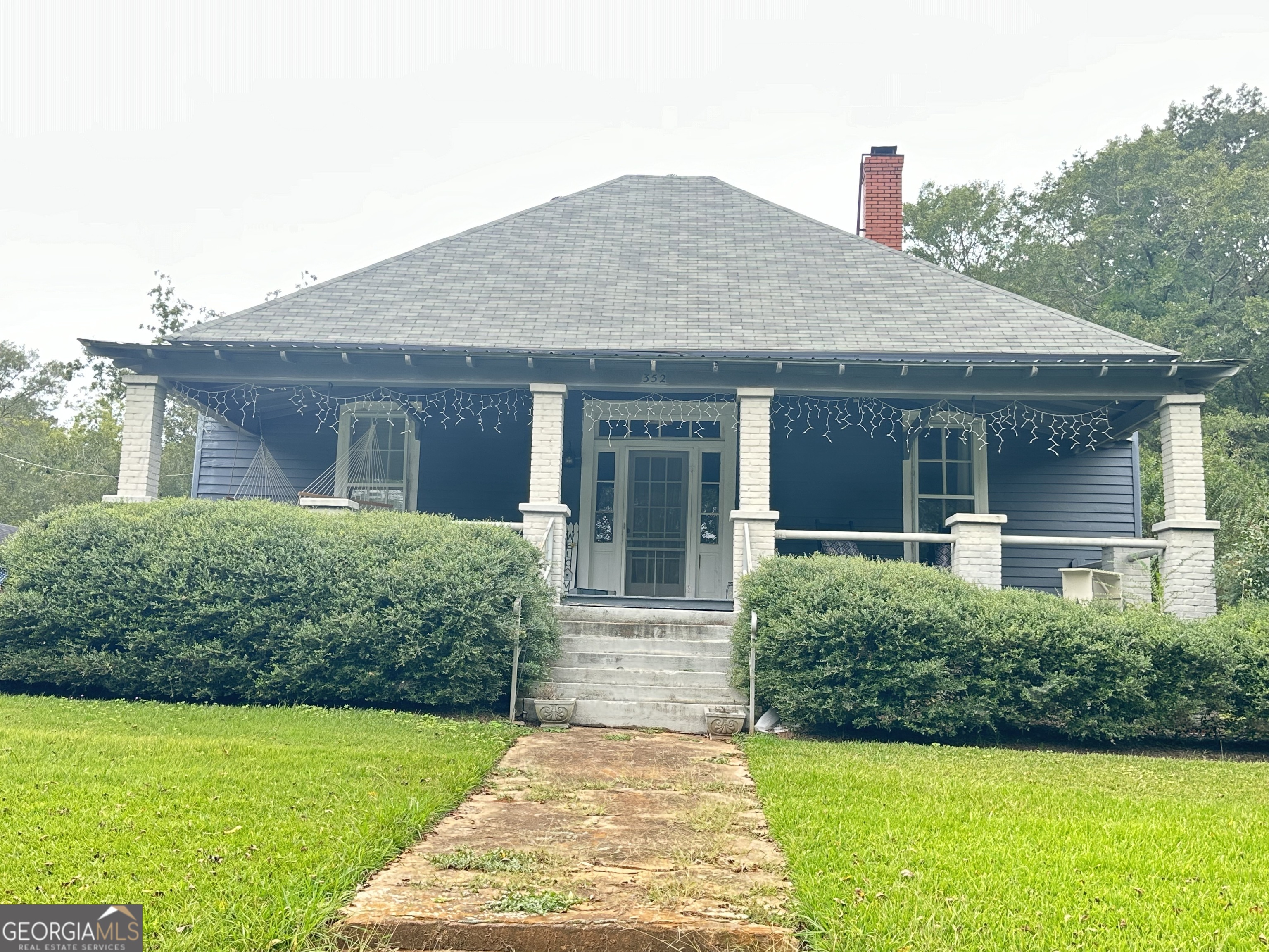 a front view of a house with garden