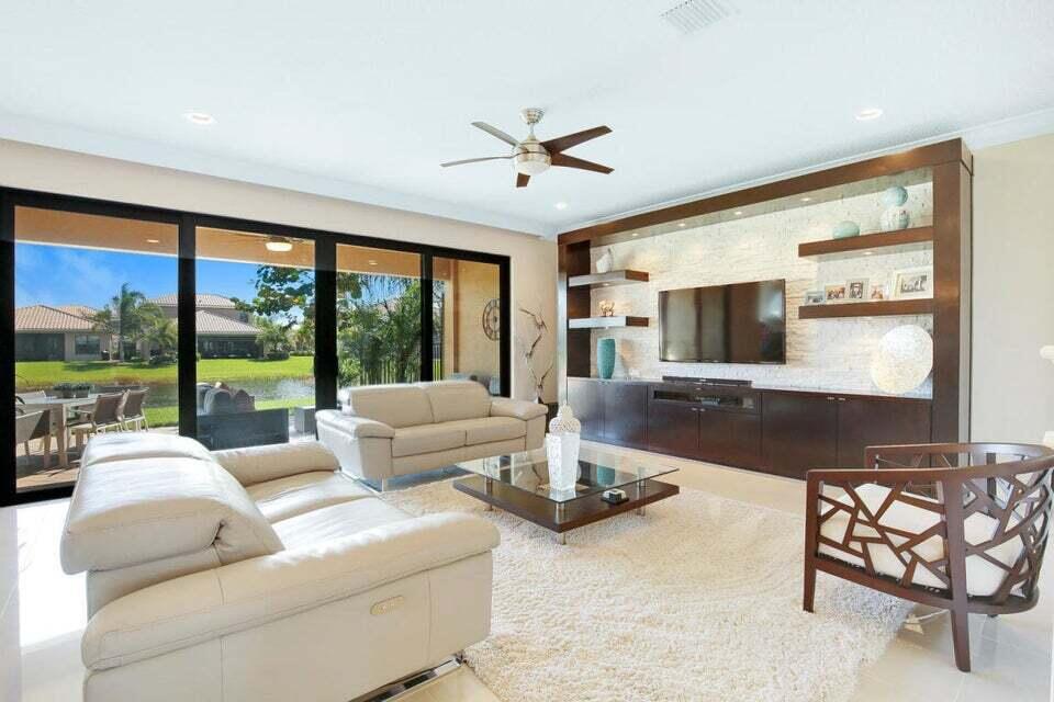 a living room with furniture tv and large window