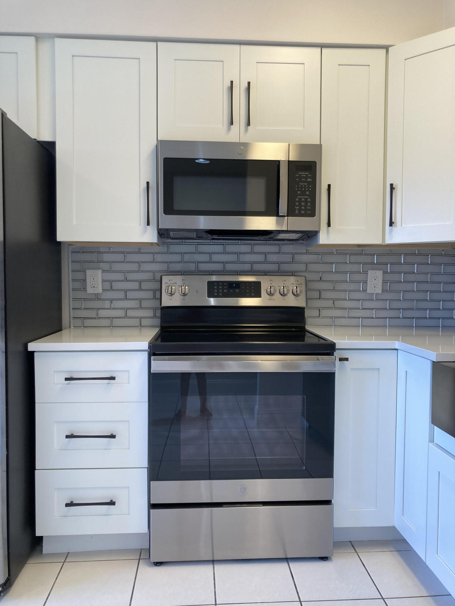 a kitchen with a stove and a microwave