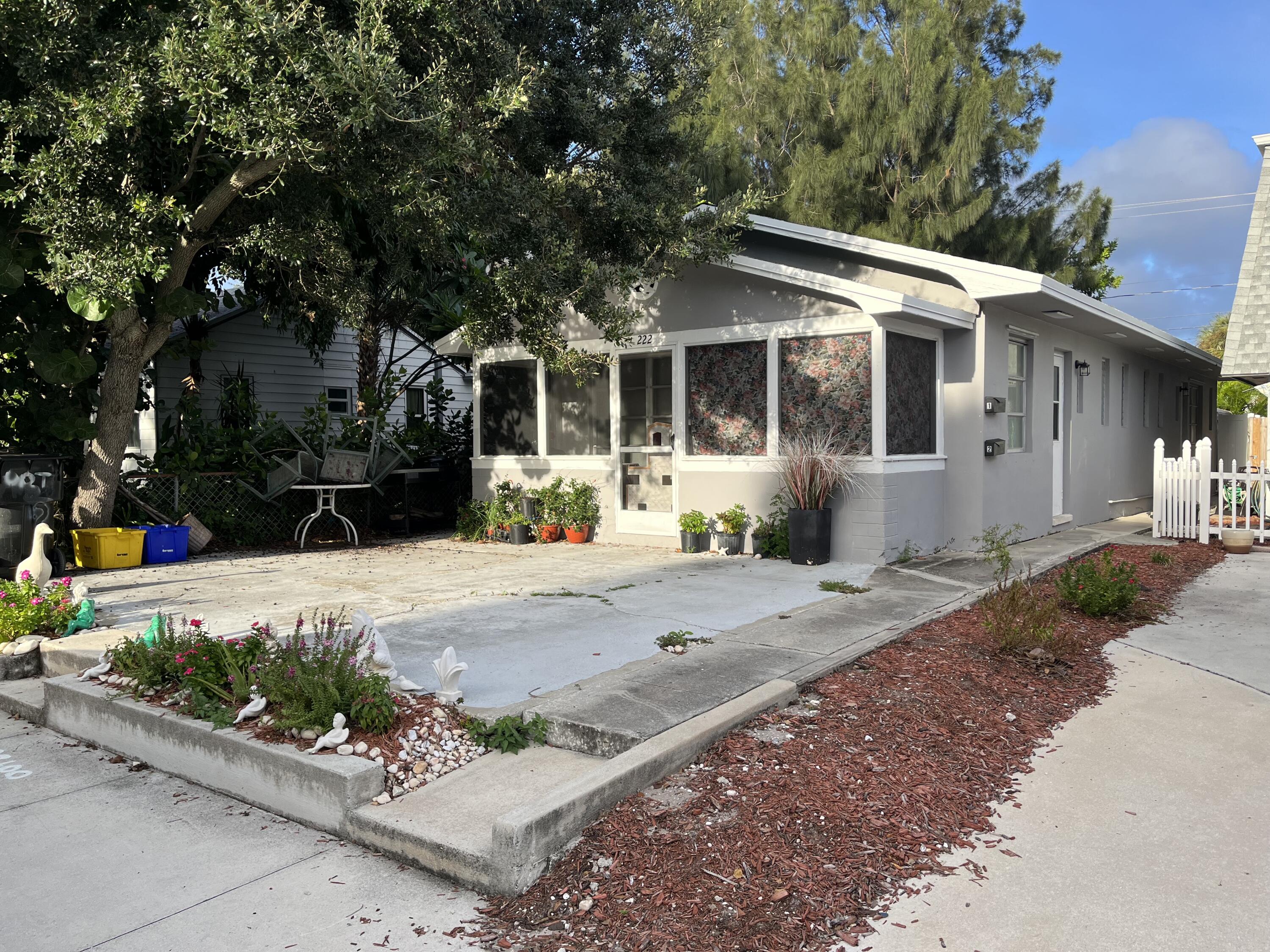 a front view of a house with a garden and patio